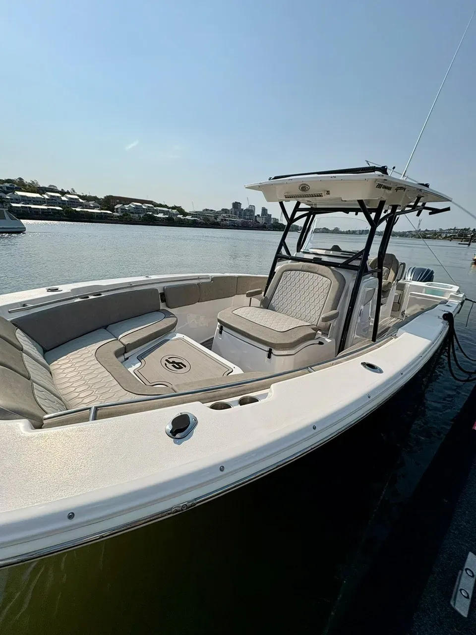 A freshly detailed centre console moored on the Brisbane River, T-top and clean upholstery on show