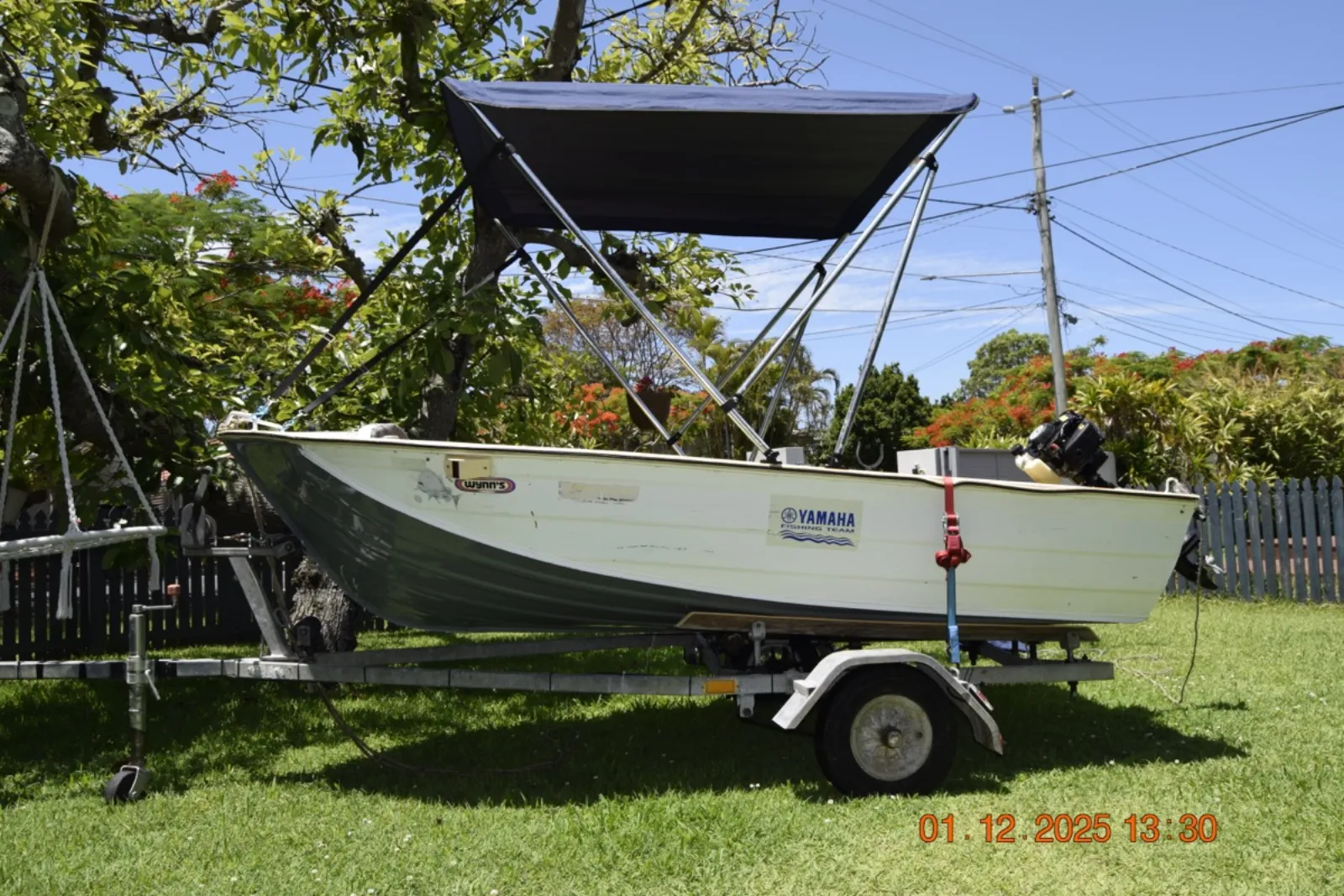 Tinny with Bimini Cover on the water